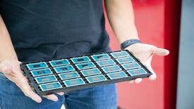 A man holds a tray of Intel Core Ultra CPUs.